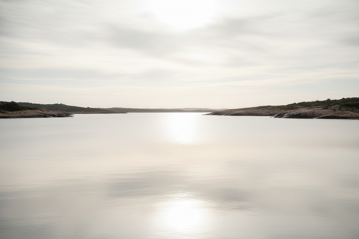 Cinematic photorealistic image of soft sunlight reflecting across calm water, forming a bright line between two shores. Neutral beige and silver tones, smooth gradients, high-end editorial mood, representing unity and responsible engagement.